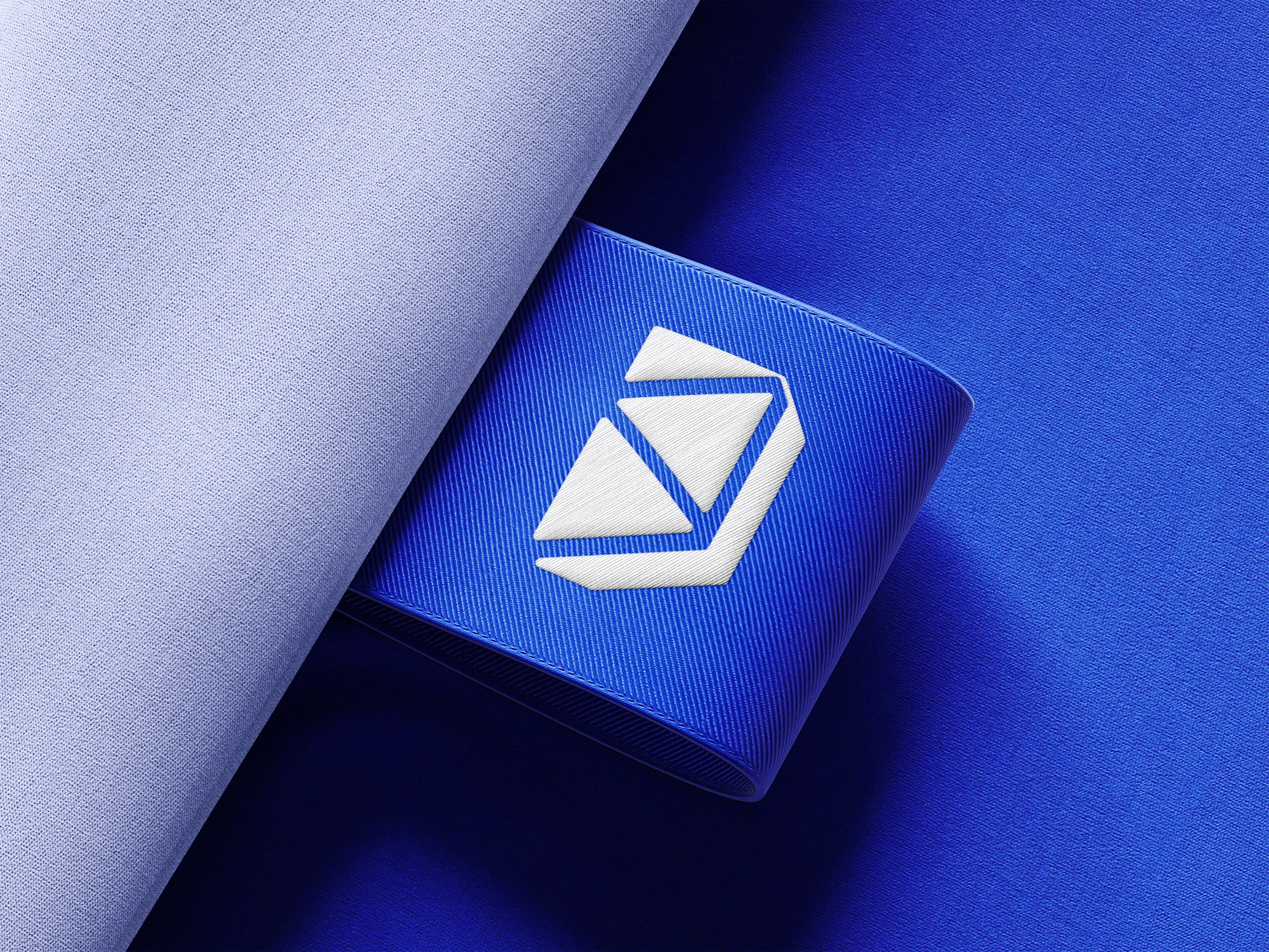 White Digi-Realm symbol on a blue clothing label mockup